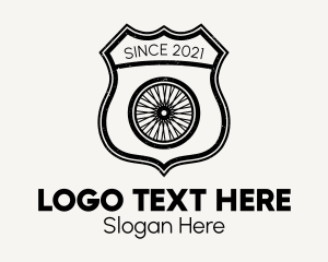 Pedal - Rustic Bicycle Wheel Shield logo design