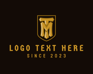 Video Game - Golden Shield Gamer Letter TM logo design