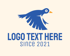 Cross - Flying Blue Pigeon logo design